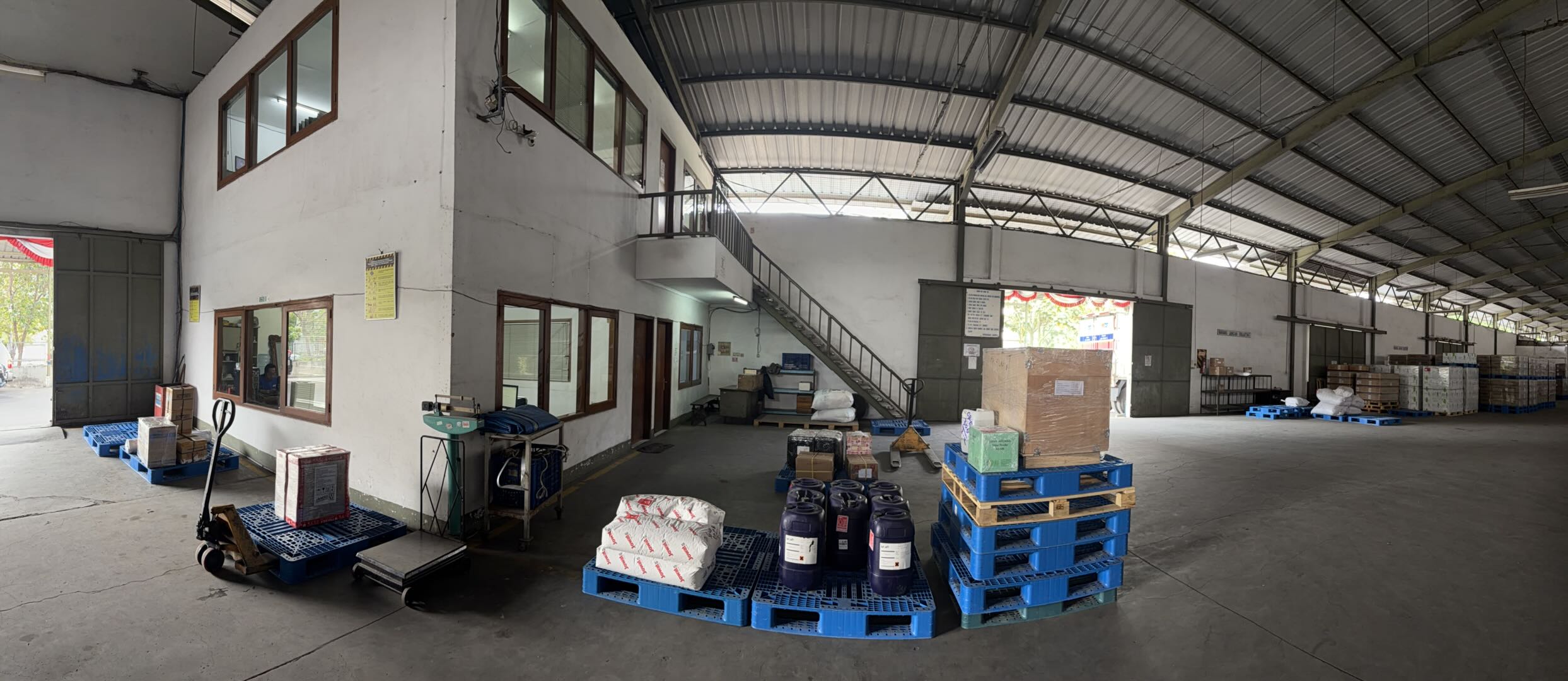 Industrial warehouse environment with pallets and storage racks