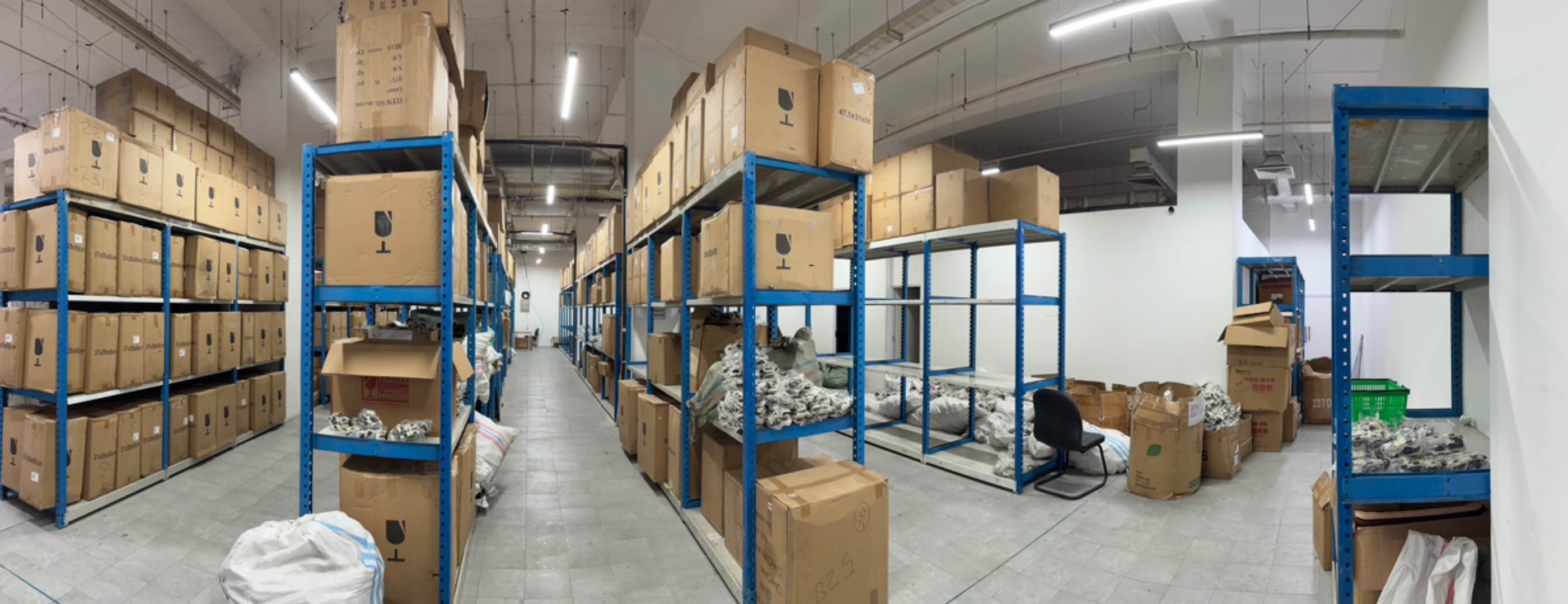 A logistics stockroom with shelving and varied inventory