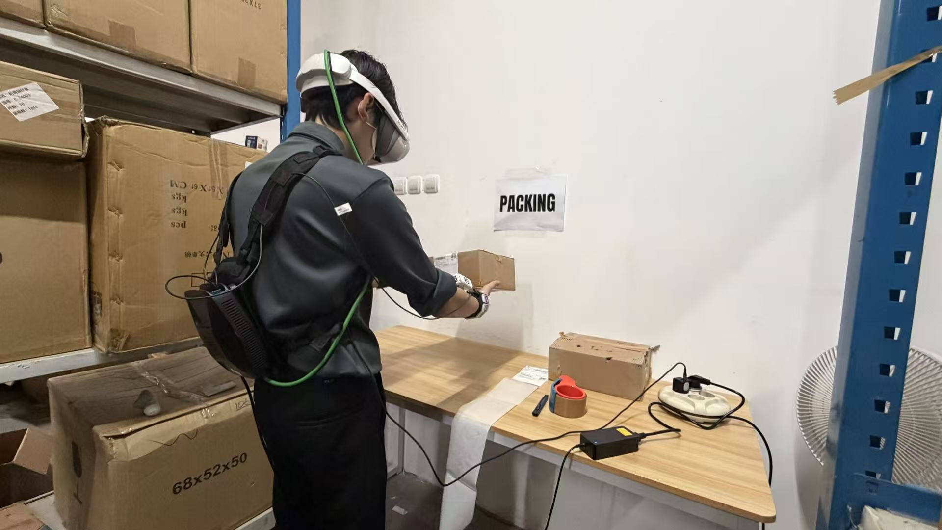 Wearable data collection operator performing a packing task
