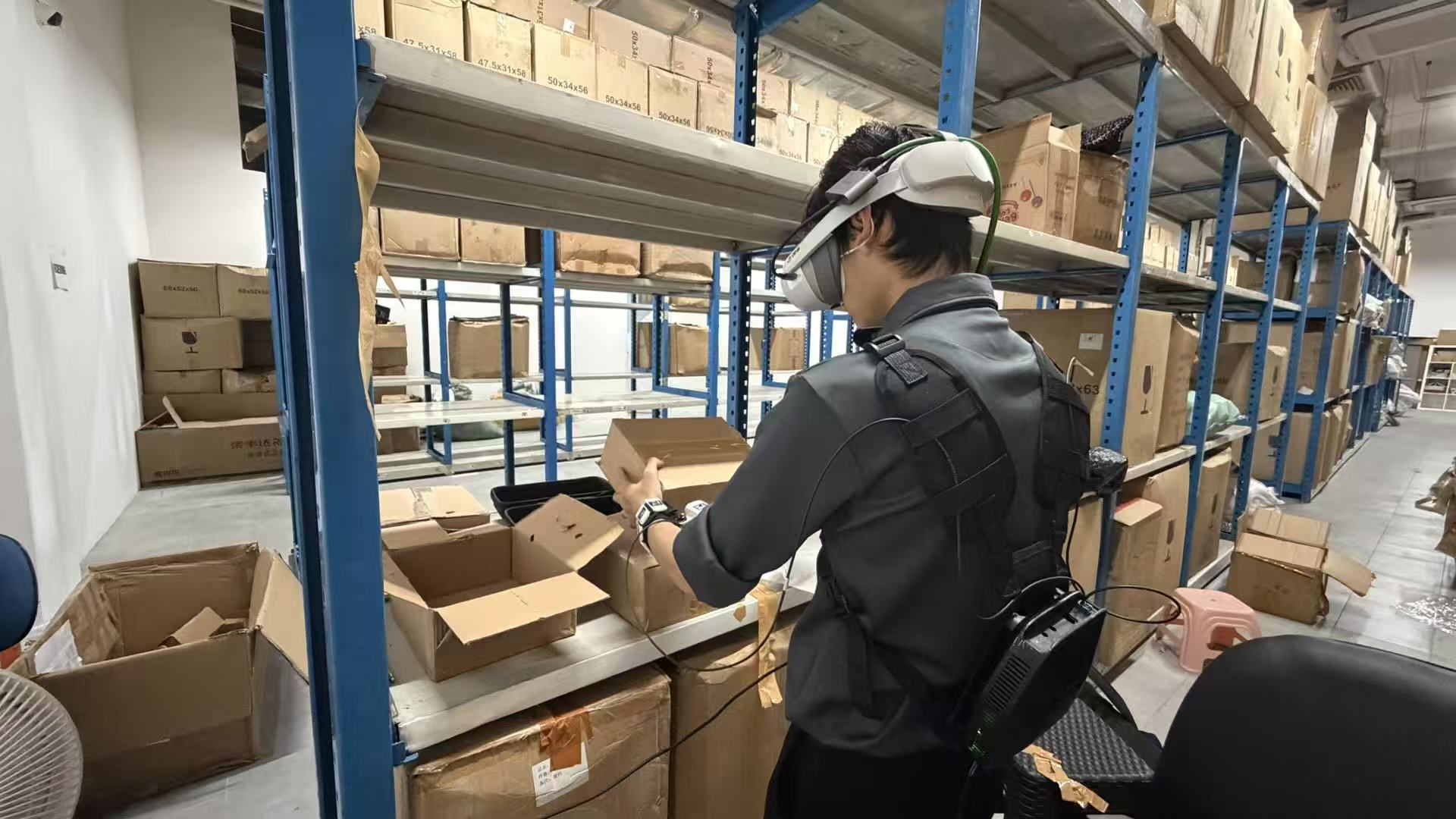 An operator using a wearable capture system while handling a package in a warehouse